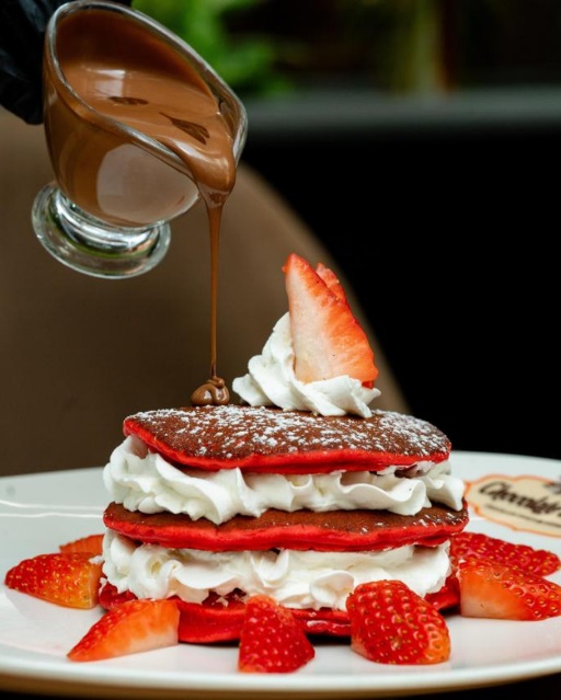 Red velvet pancake stack with chocolate and strawberries